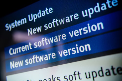Close-up of a computer screen displaying system update and new software version notifications