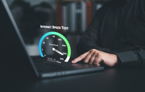 Person running an internet speed test on a laptop showing a 325 Mbps download speed
