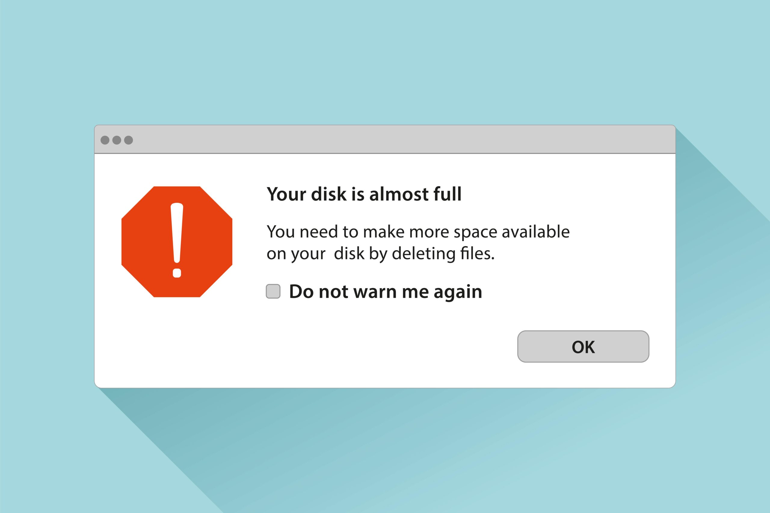 Computer alert message warning that disk is almost full with option to delete files
