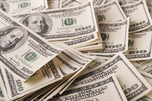 Stacks of one hundred dollar bills representing wealth, cash, or financial success
