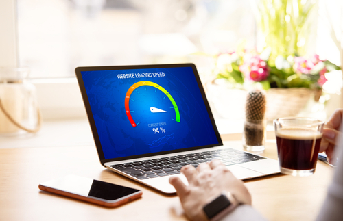 Person checking website loading speed on laptop showing 94% performance