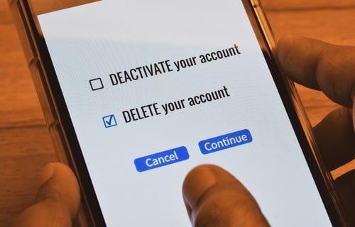Person selecting option to delete account on smartphone screen