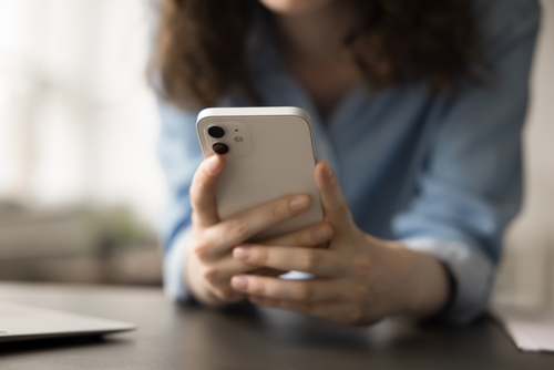 Close-up of woman using smartphone, representing daily digital usage and online connectivity