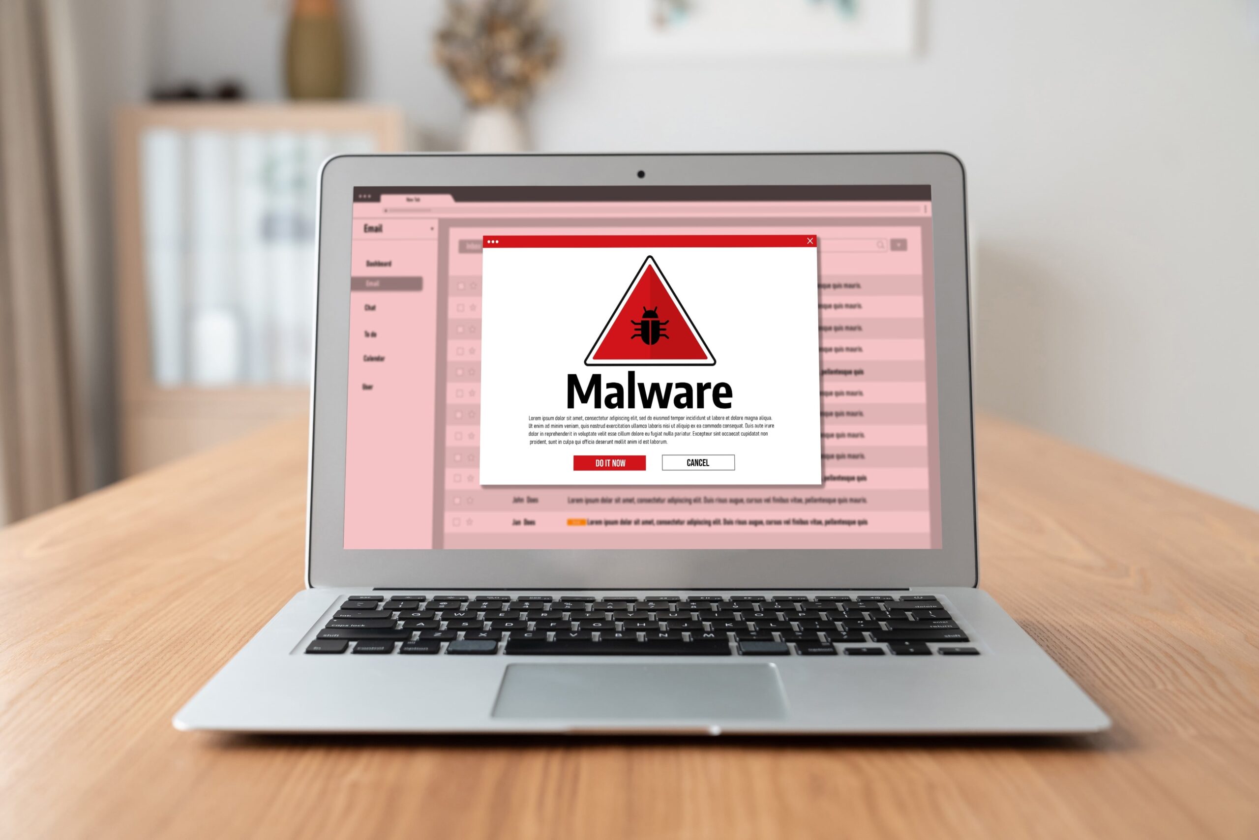 Laptop screen displaying malware alert warning from email inbox, indicating cybersecurity threat