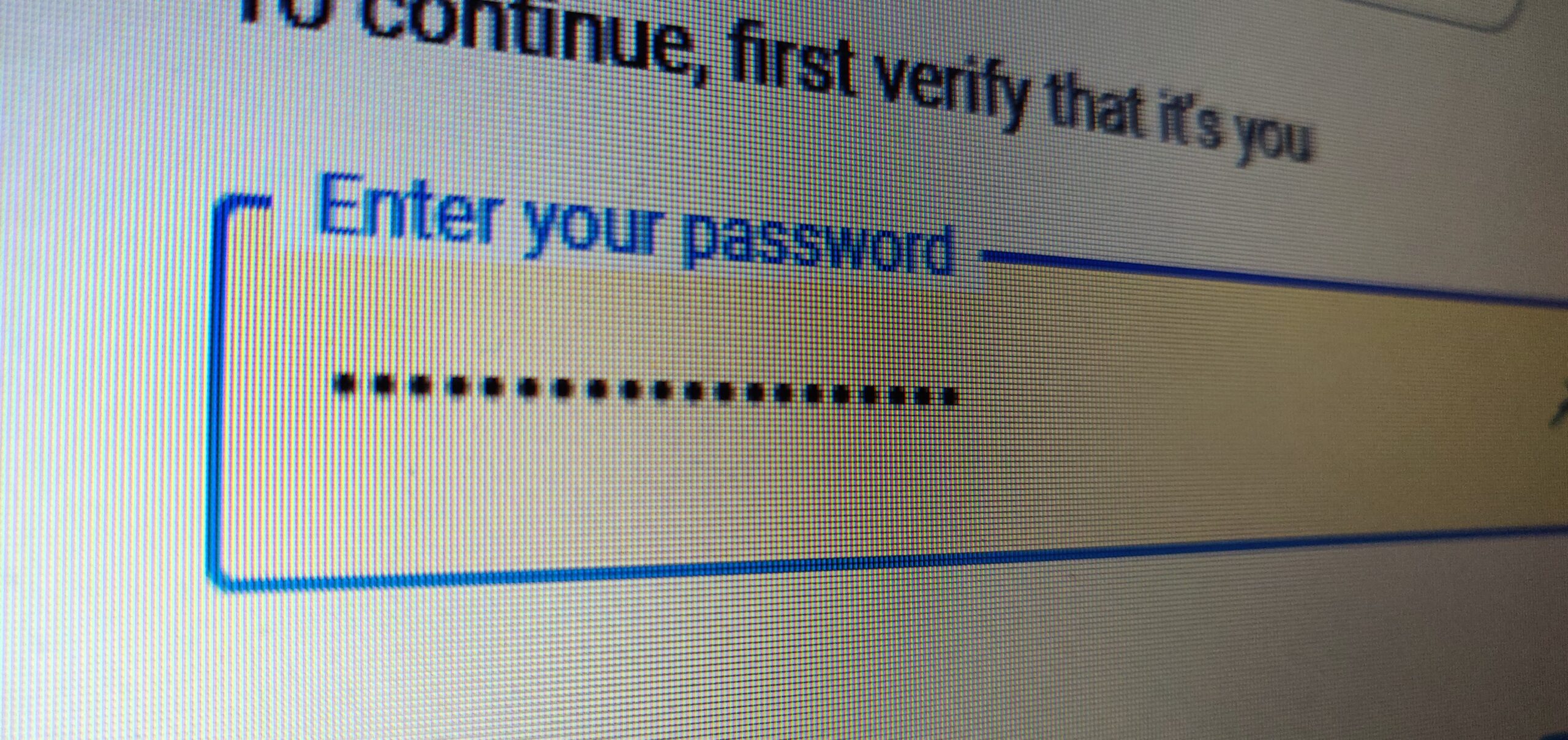 Close-up of a password entry field on a login screen with hidden characters