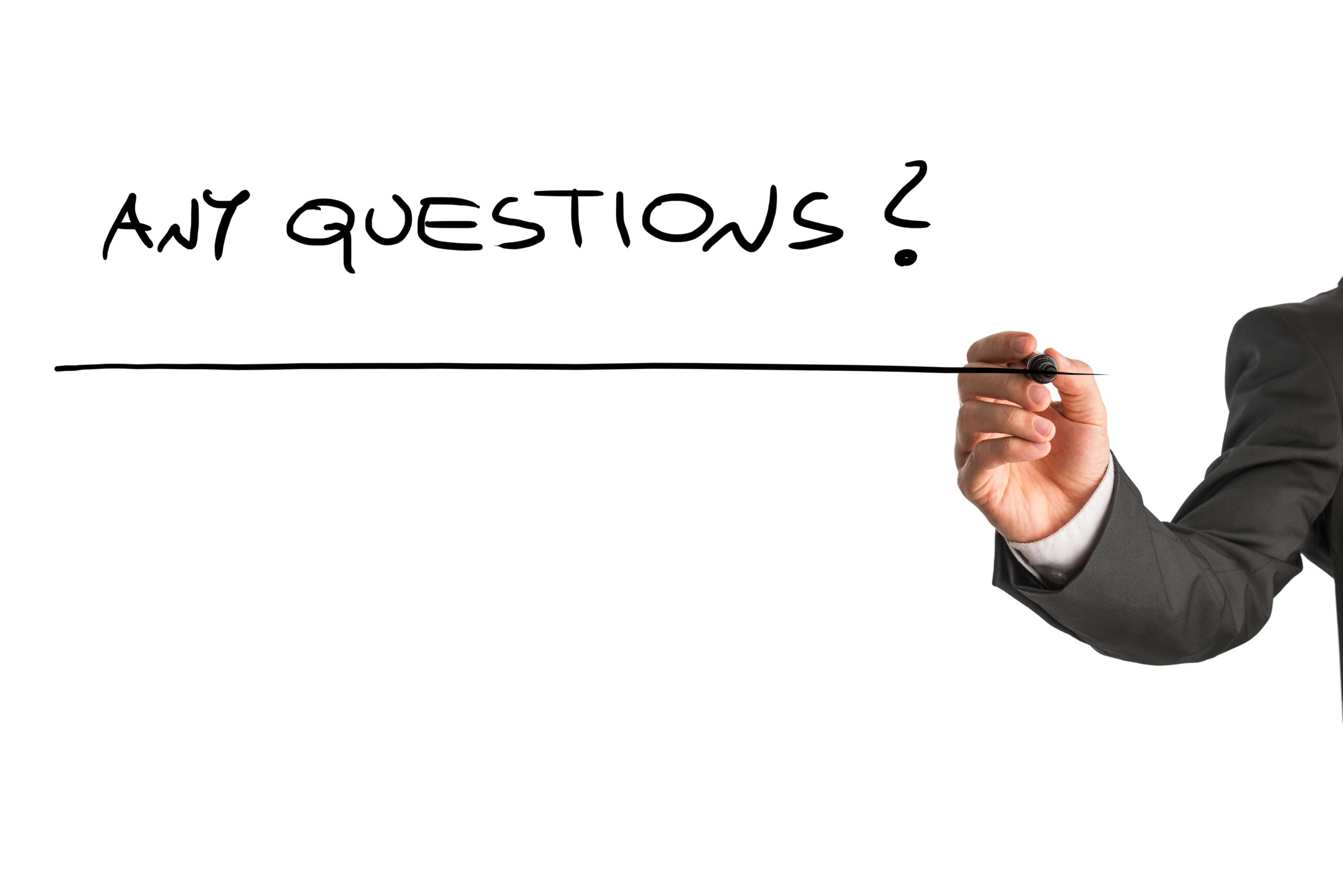 Businessman writing 'Any Questions?' with black marker on white background