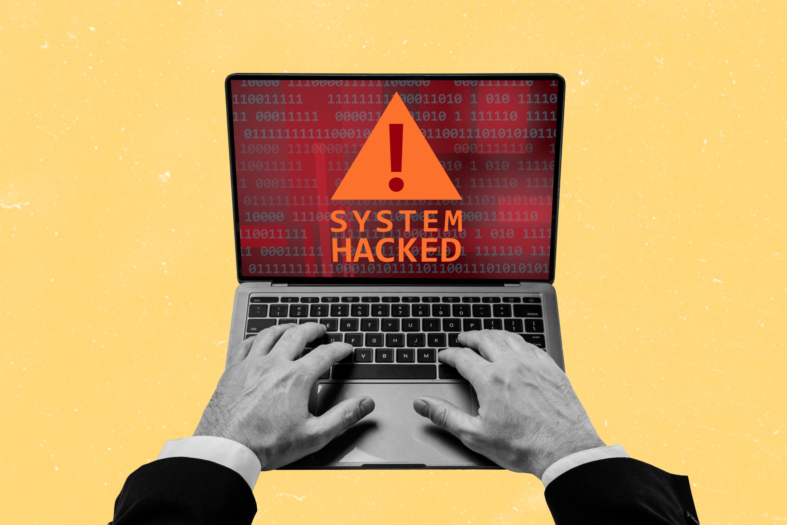 Abstract collage with hands on a mac keyboard and the screen glowing red saying "system hacked"