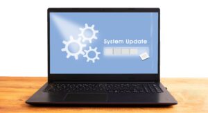 A laptop screen displaying a system update progress bar that is almost complete.