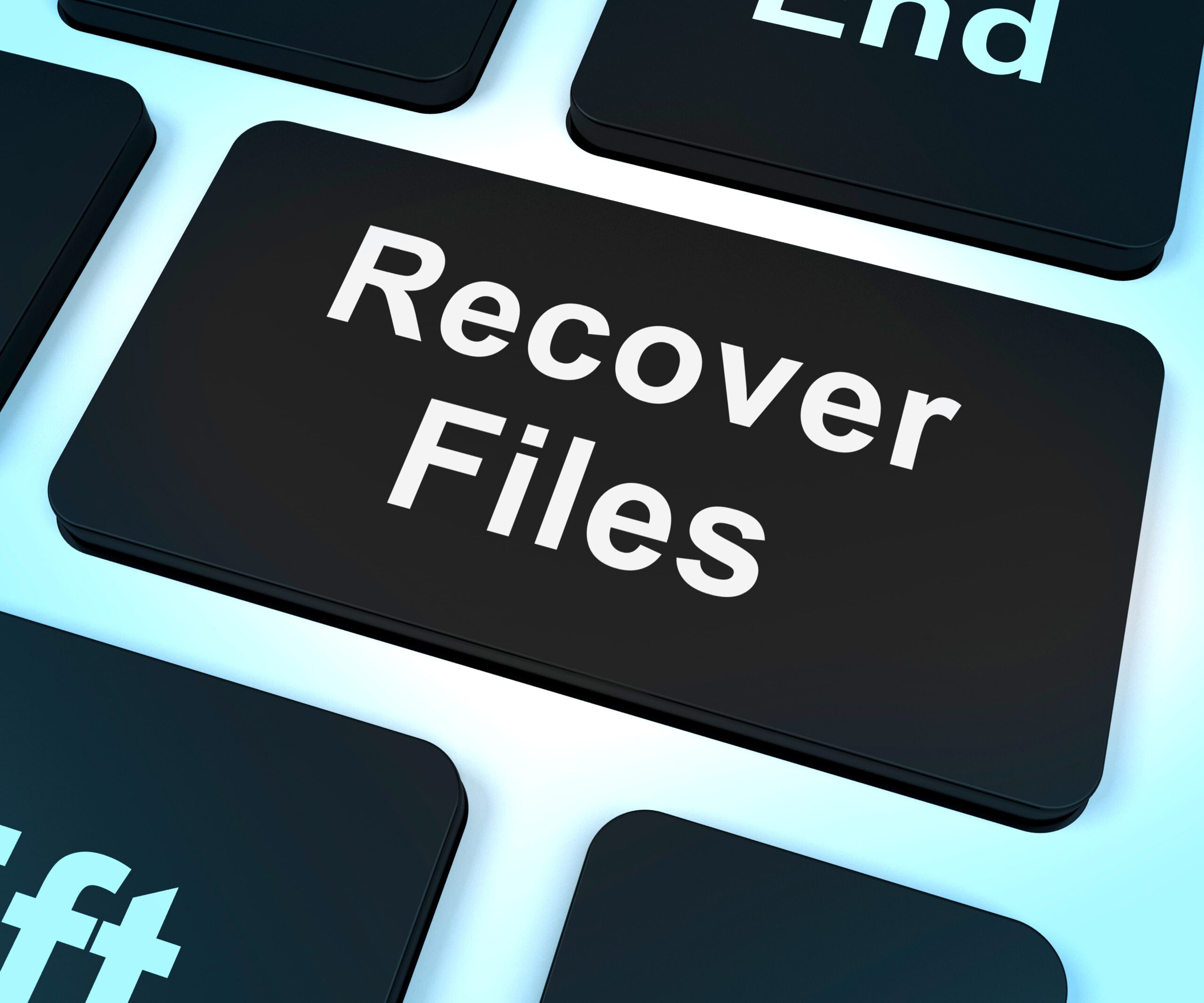 A close-up of a keyboard key displaying “Recover Files”