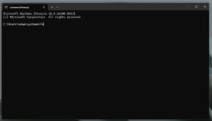 Windows Command Prompt displaying system version information with the command “systeminfo” typed.