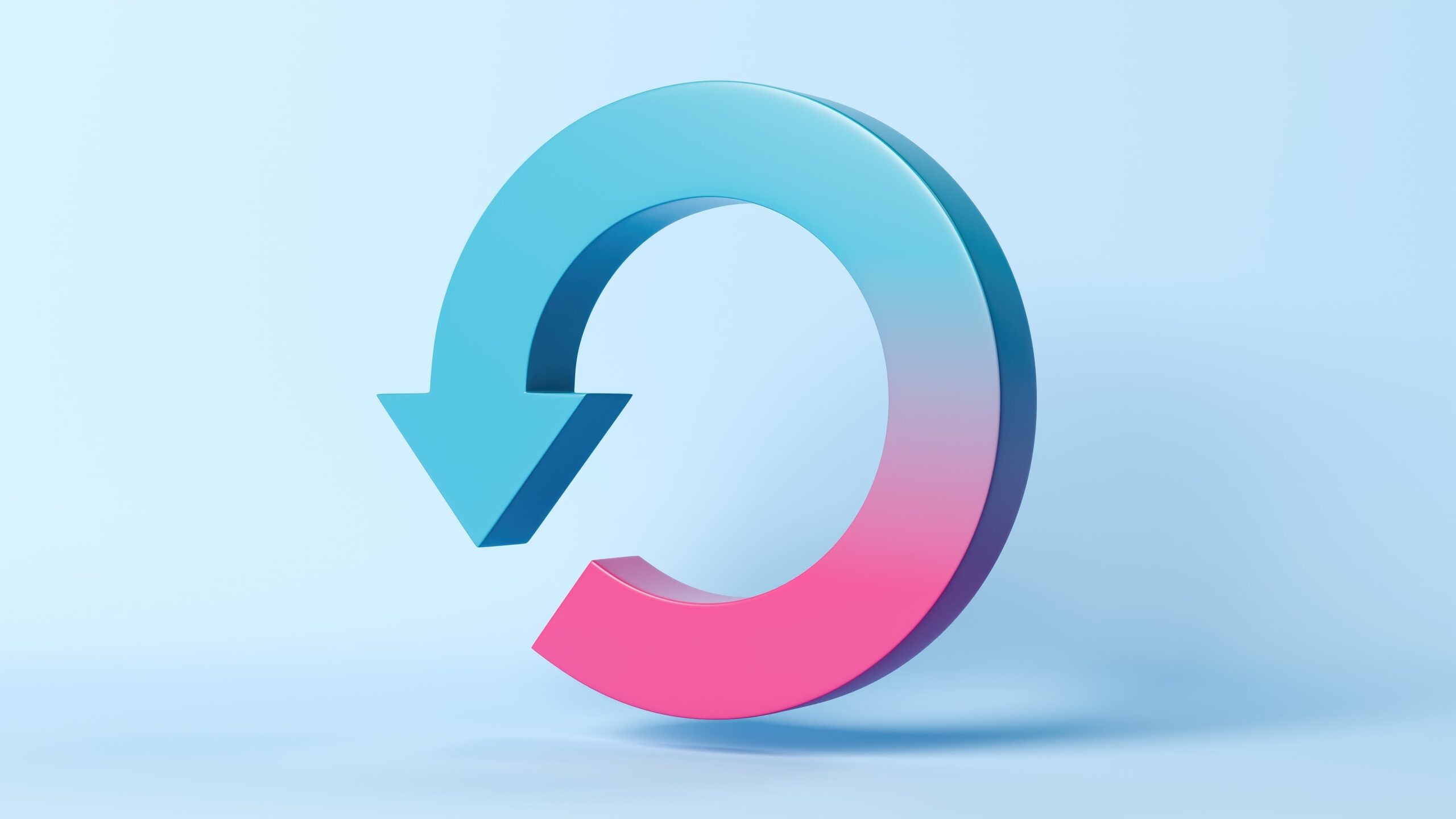 3D gradient refresh or reload arrow icon in blue and pink tones on a light blue background.