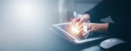 Person typing on a laptop with digital security icons, representing secure access to online accounts