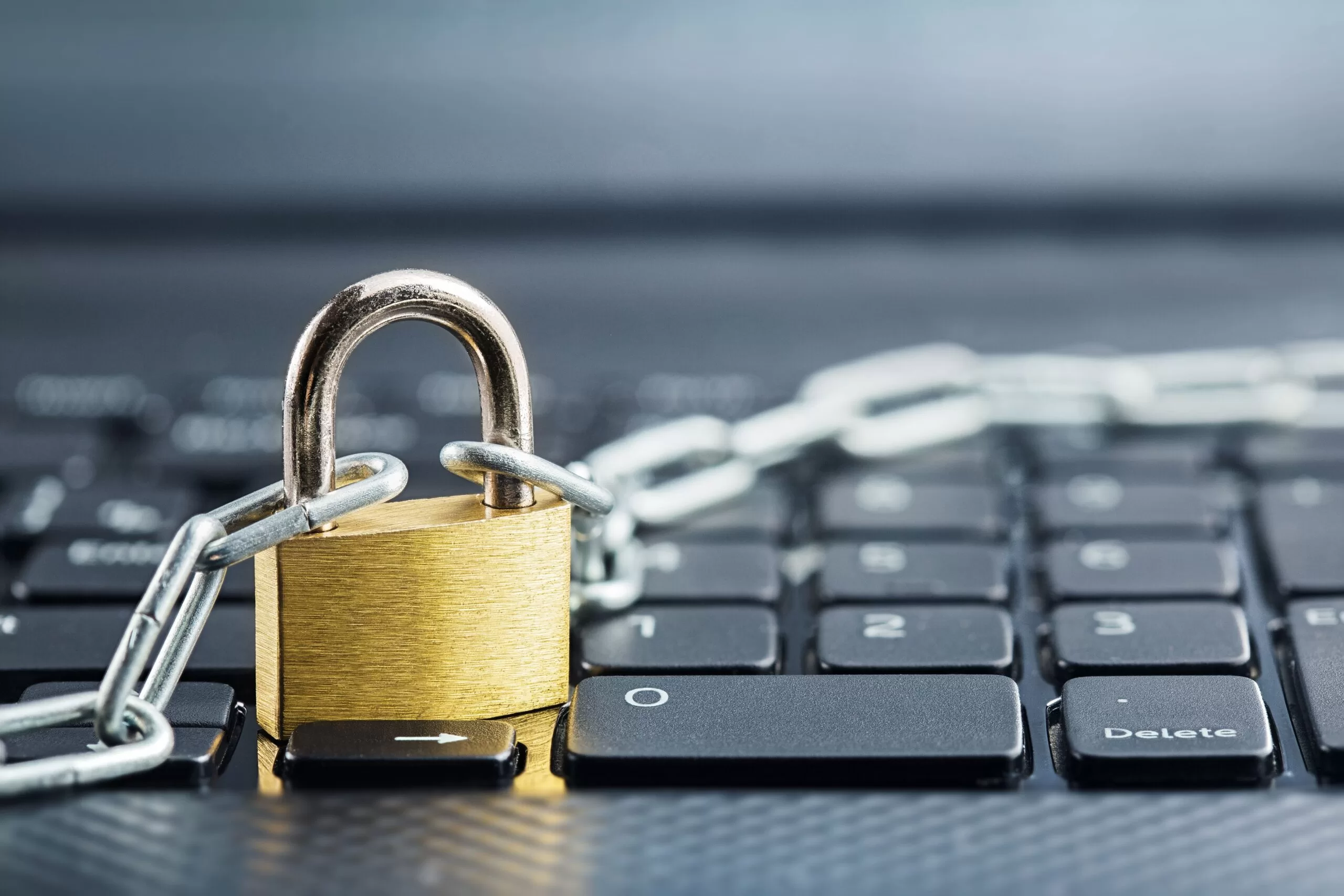 Padlock and chain on a laptop keyboard