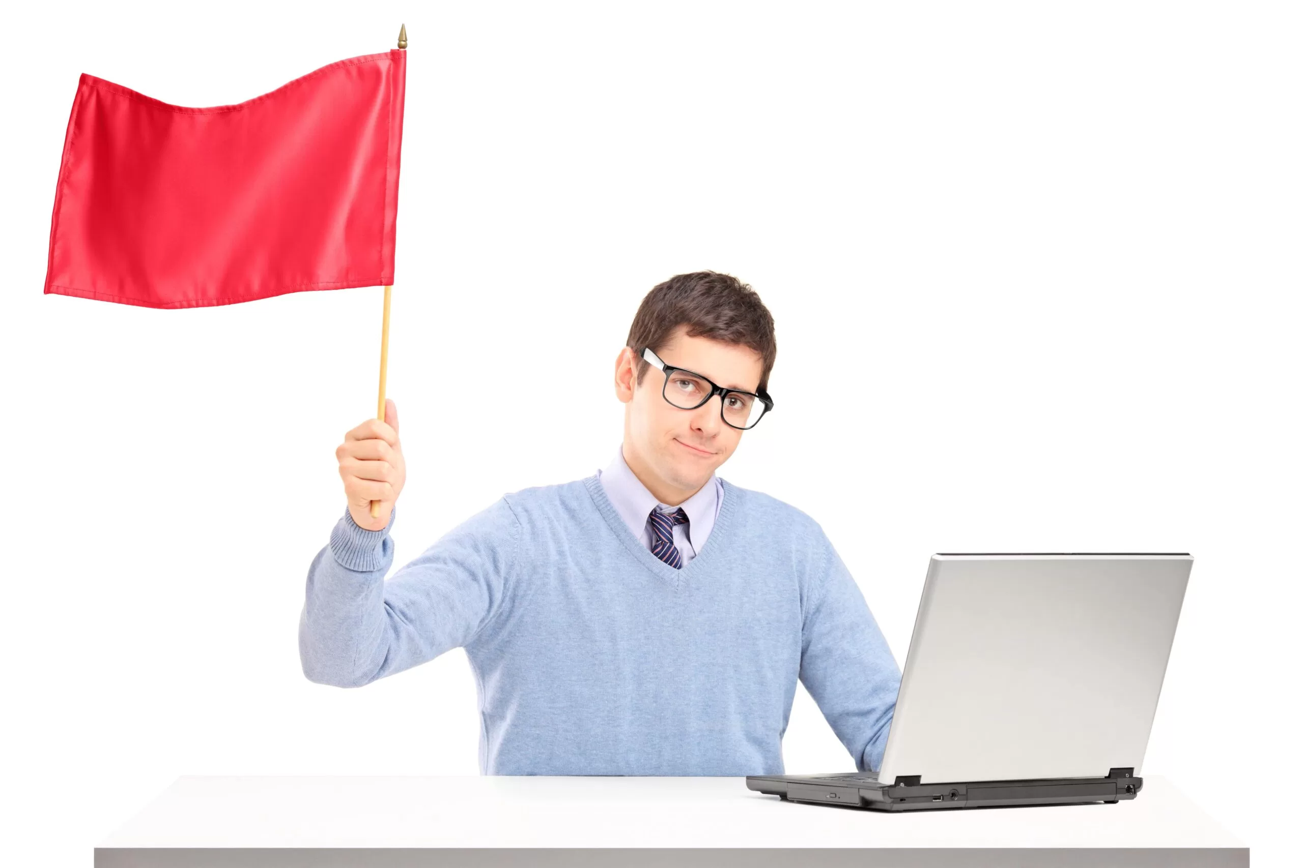 man sitting with laptop and waving a red flag