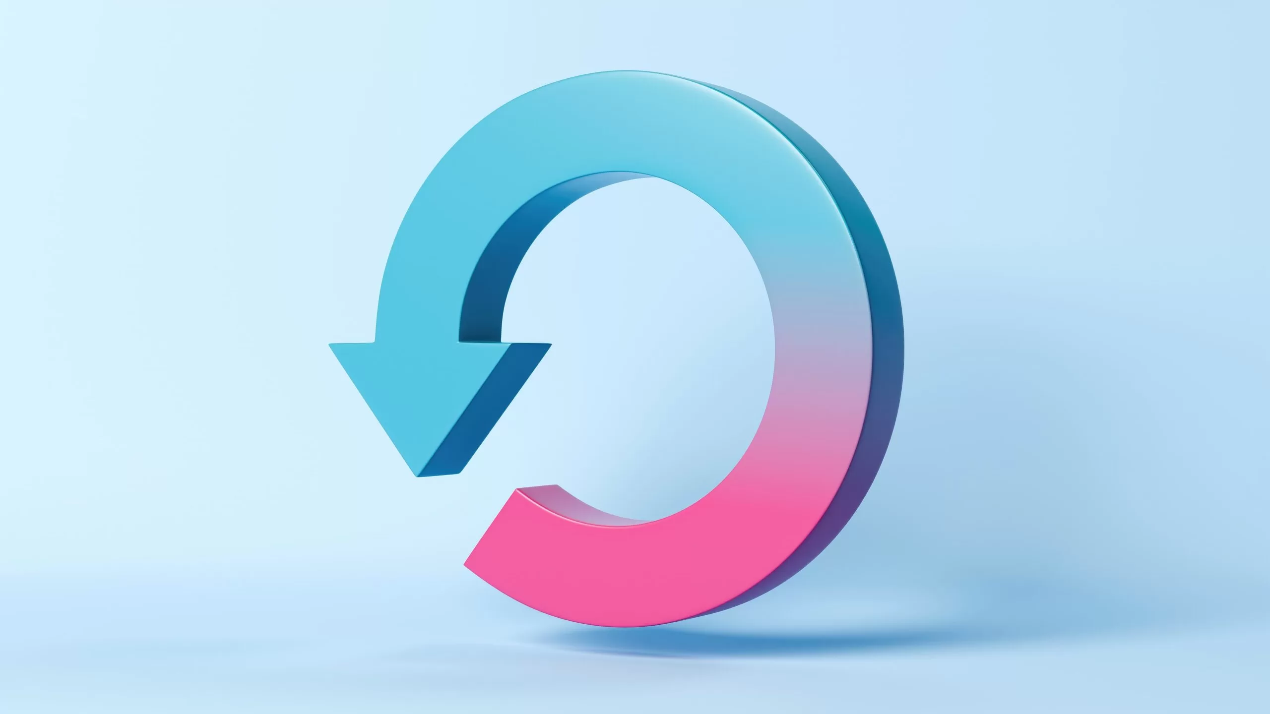 3D gradient refresh or reload arrow icon in blue and pink tones on a light blue background.